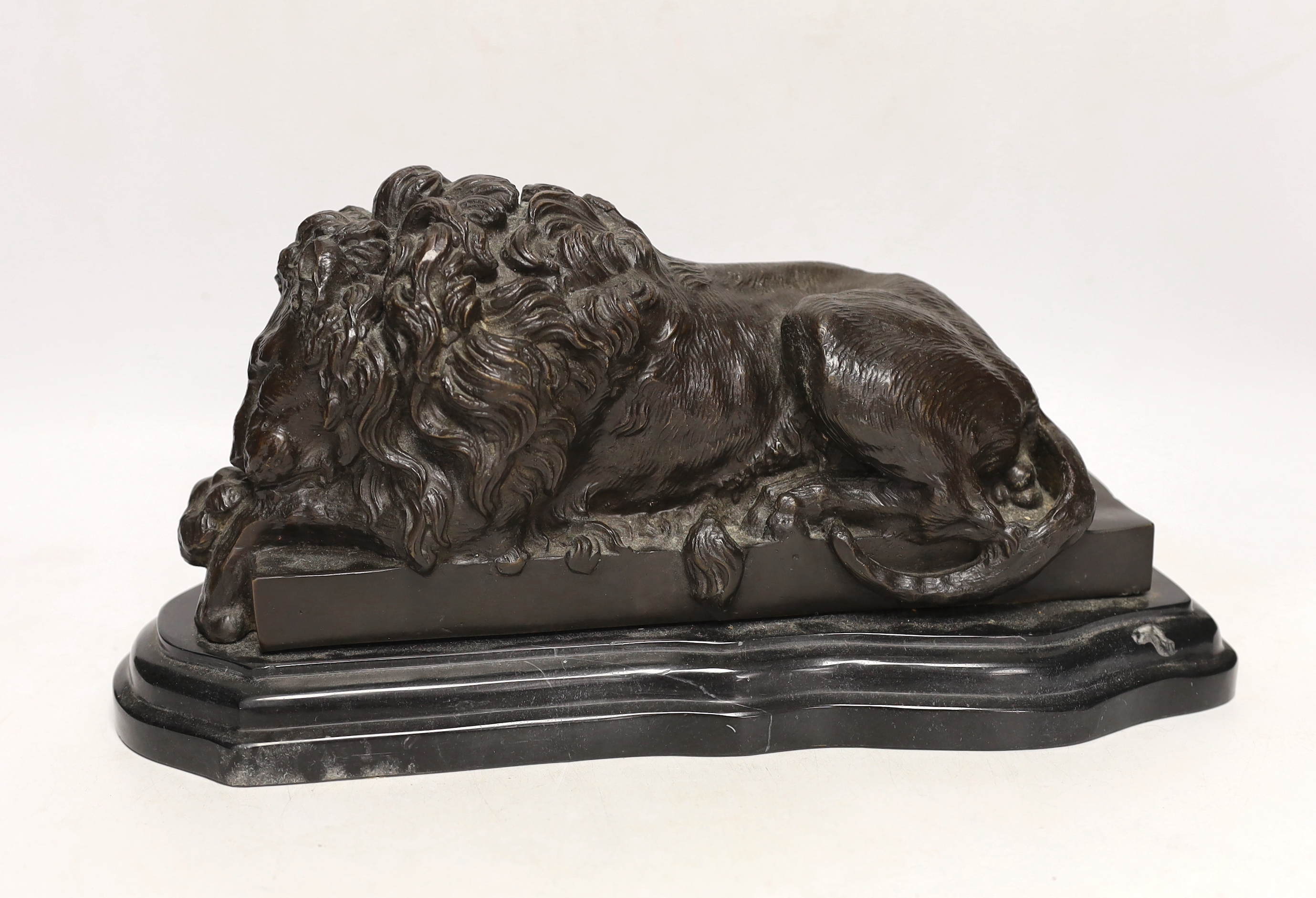 After Isadore Bonheur, a bronze figure of a recumbent lion, raised on marble base, 35cm wide